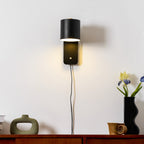 Rotatable cylinder wall lamp shown beside a framed wall print