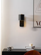 Cordless cylinder wall lamp in white on a bedroom wall