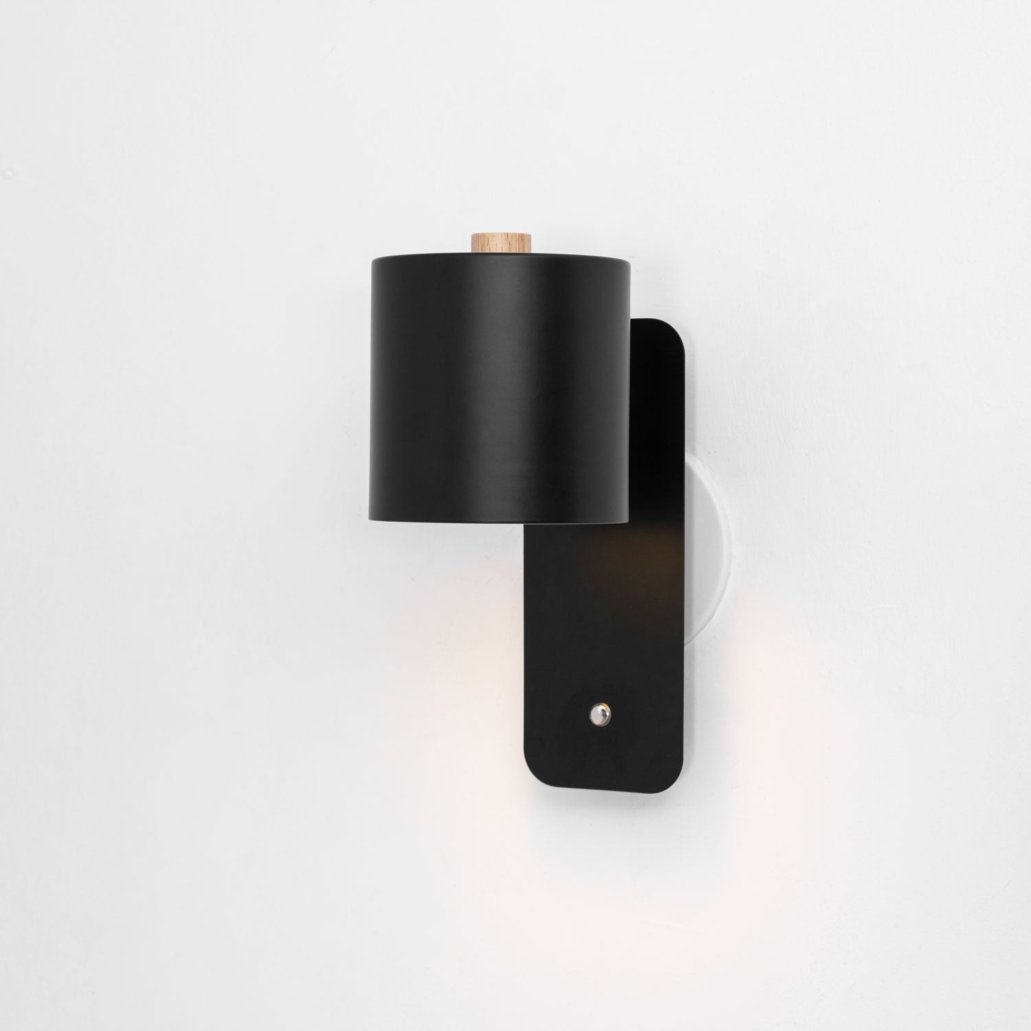 Cylinder wall lamp shade rotated to uplight the wall