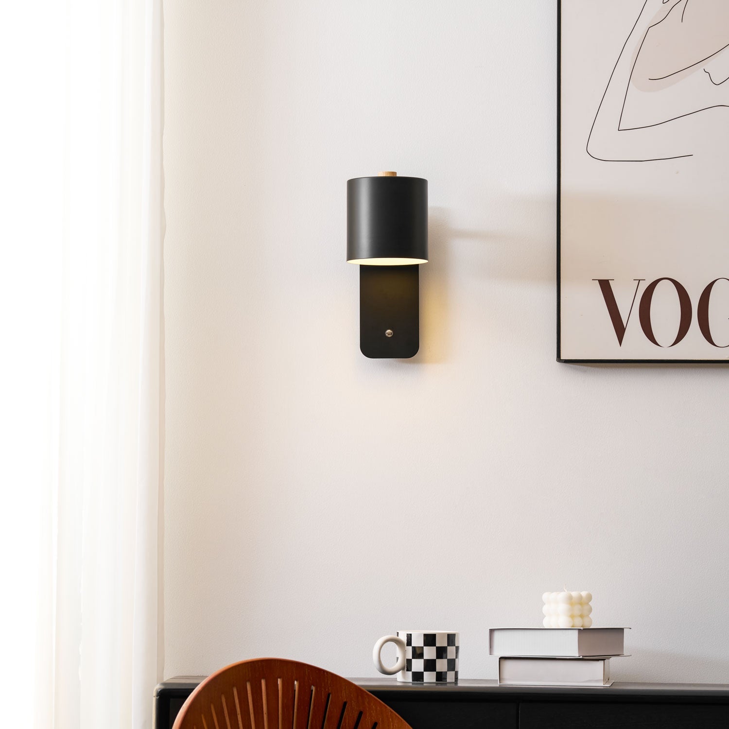 Cylinder wall lamp in green mounted near a mirror