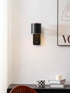 Cylinder wall lamp in black with shade rotated down