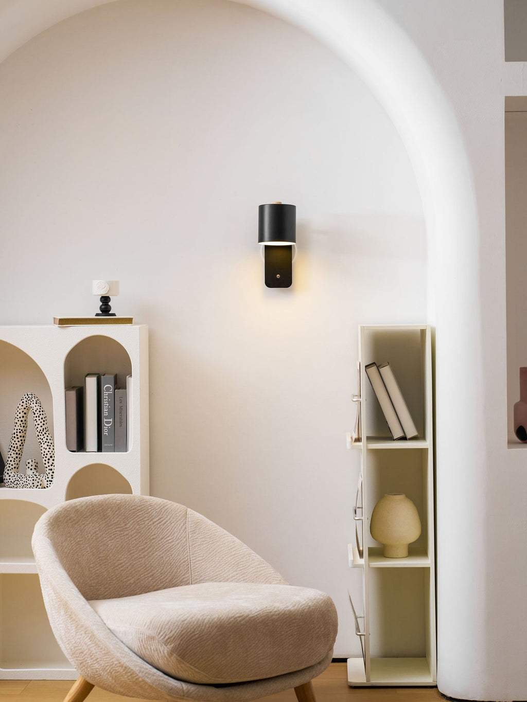 Rechargeable cylinder wall lamp lighting a vanity area