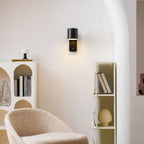 Cylinder wall lamp glowing in a darkened bedroom