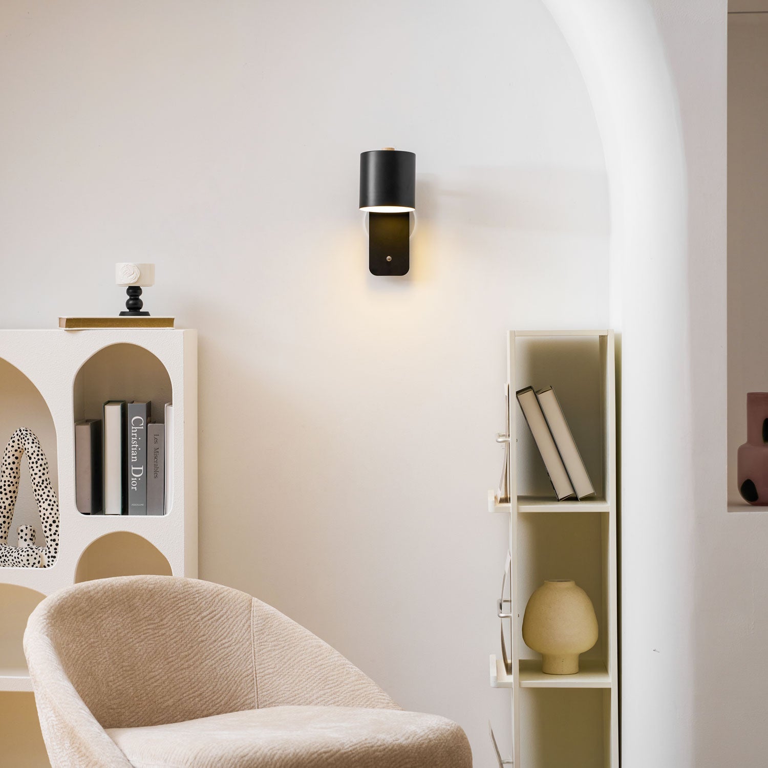 Cylinder wall lamp glowing in a darkened bedroom
