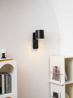 Cordless cylinder wall lamp mounted with adhesive strip