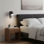 Wall lamp with cylinder shade casting warm light indoors