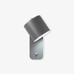 Cylinder wall lamp shown projecting from a painted wall