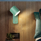 Slim metal cylinder wall lamp mounted on a wall