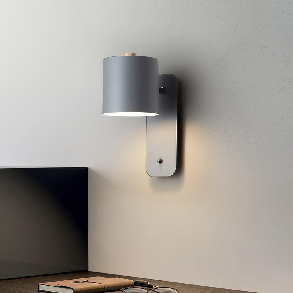 Cordless cylinder wall lamp lighting a hallway corner