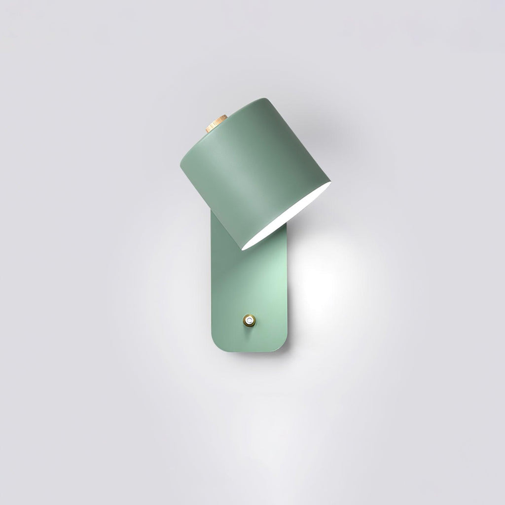 Matte cylinder wall lamp angled to wash light up a wall