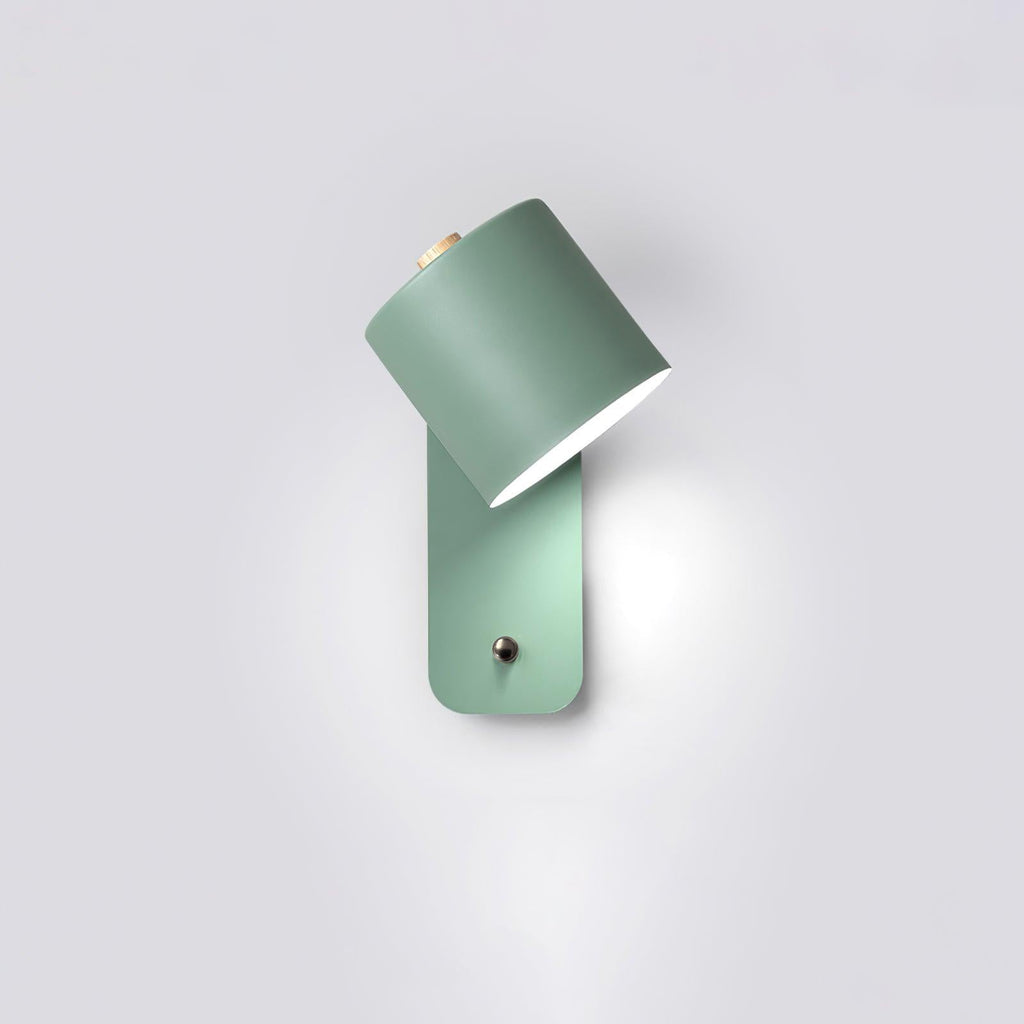 Cordless cylinder wall lamp glowing softly on a wall