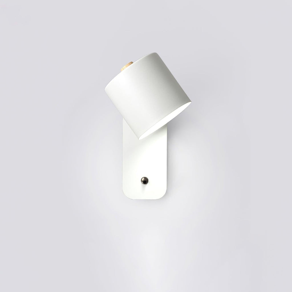 Cordless cylinder wall lamp mounted beside a bed