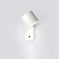 Cordless cylinder wall lamp mounted beside a bed