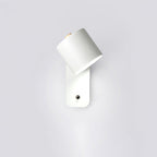 Cordless cylinder wall lamp mounted beside a bed