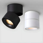 Black and white finishes of this Clérachic spotlight sit side by side, one angled and one straight down.