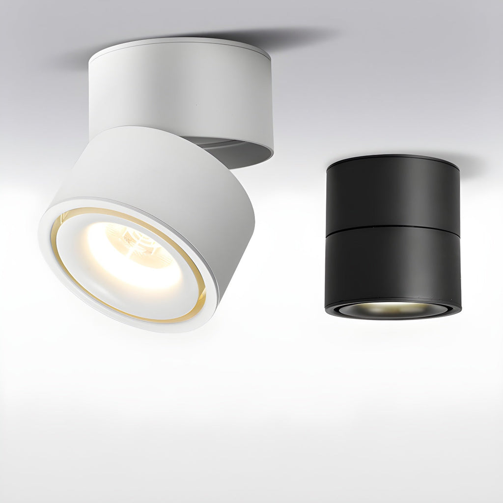 White and black finishes of this Clérachic spotlight are shown together, the white one lit with a gold-rimmed lens.