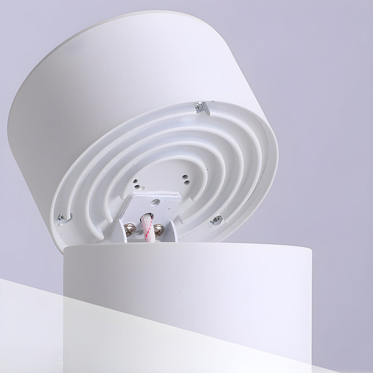 The underside of this Clérachic spotlight's white housing shows its mounting plate and screw holes.