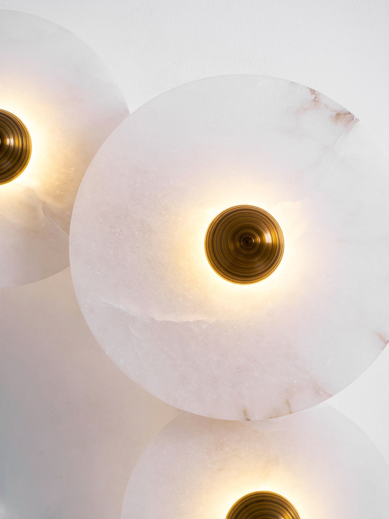 The same close crop with the light on, a bright ring of warm light circling the brass centre.