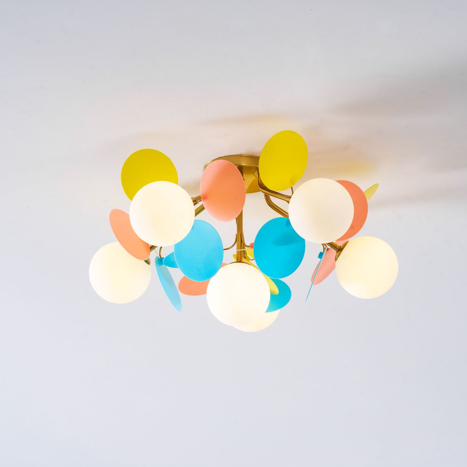 Macaron ceiling lamp with pastel discs styled in a room