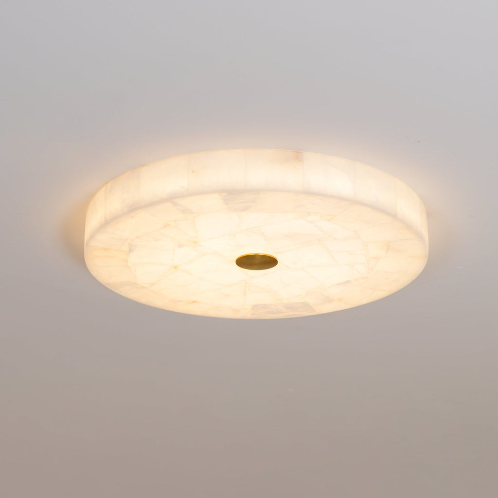 Angled view of the paler alabaster version, its finer stone mosaic lit softly on a grey ceiling