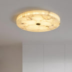 Side view of the lit flushmount on a bedroom ceiling above tall white wardrobe doors