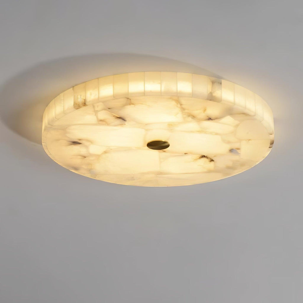 Kristy ceiling lamp lit from a low angle, warm light shining through its banded alabaster rim