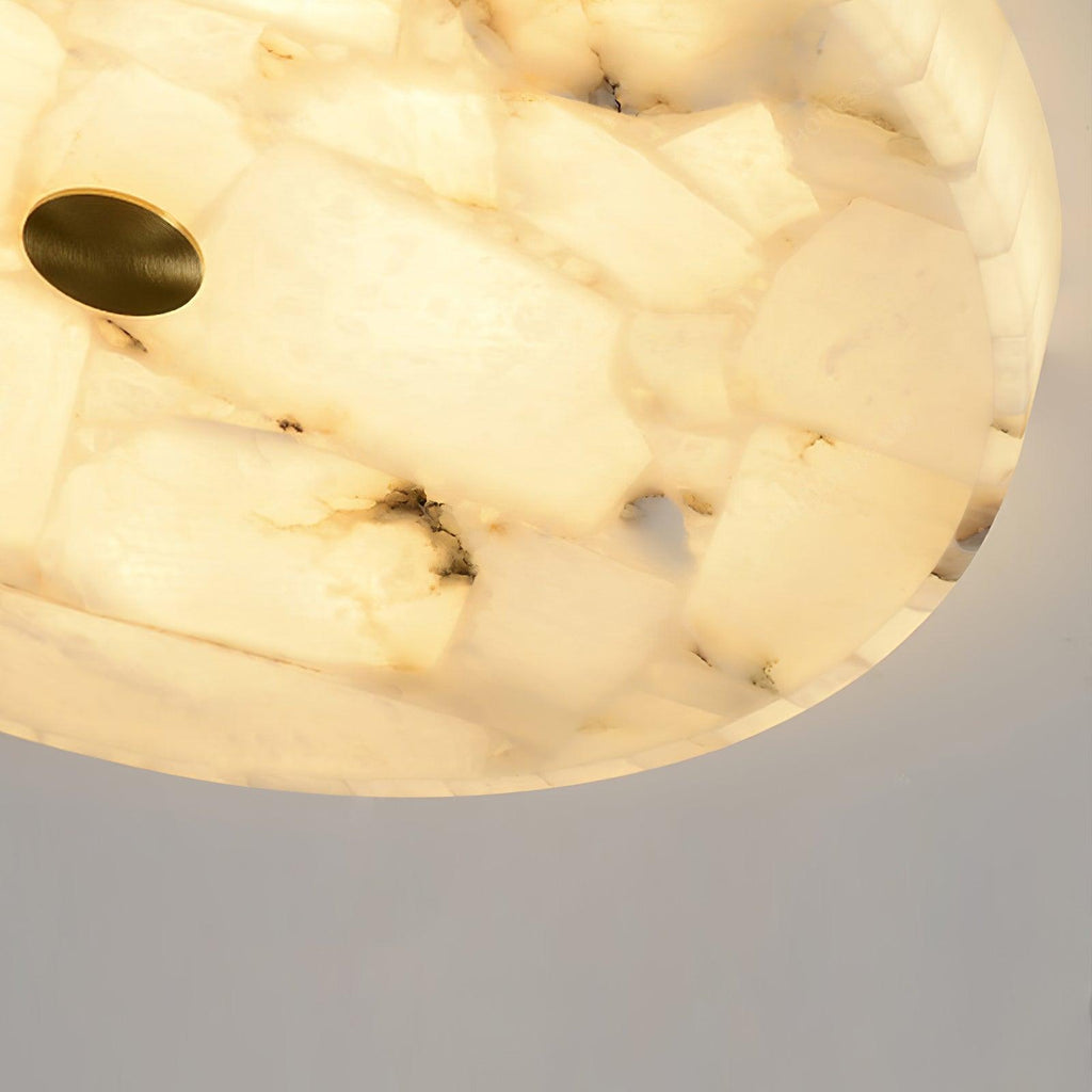 Detail crop of the fixture edge, showing individual alabaster tiles and dark mineral streaks