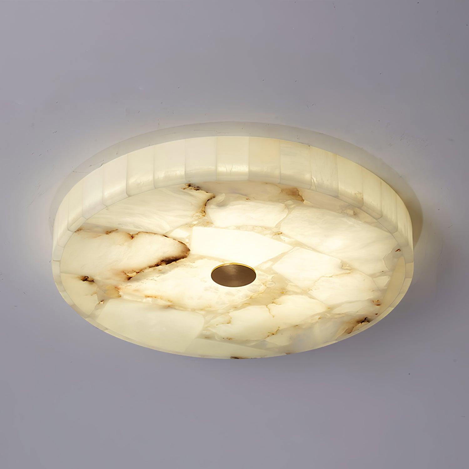 Underside of the lit Kristy ceiling lamp, dark veining running across the alabaster panels