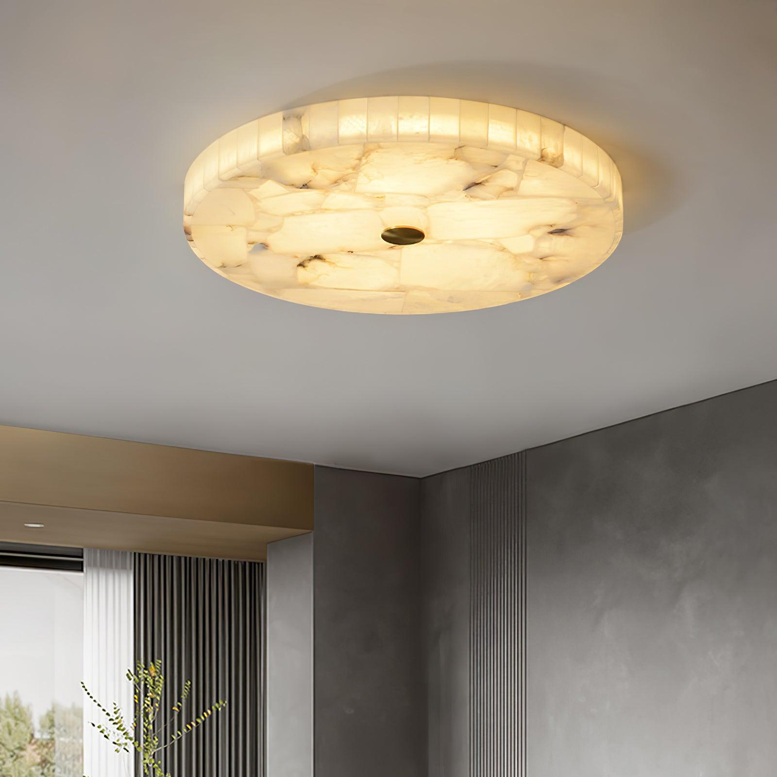 Kristy ceiling lamp lit in a grey plaster room, glow spilling toward the window and fluted screen
