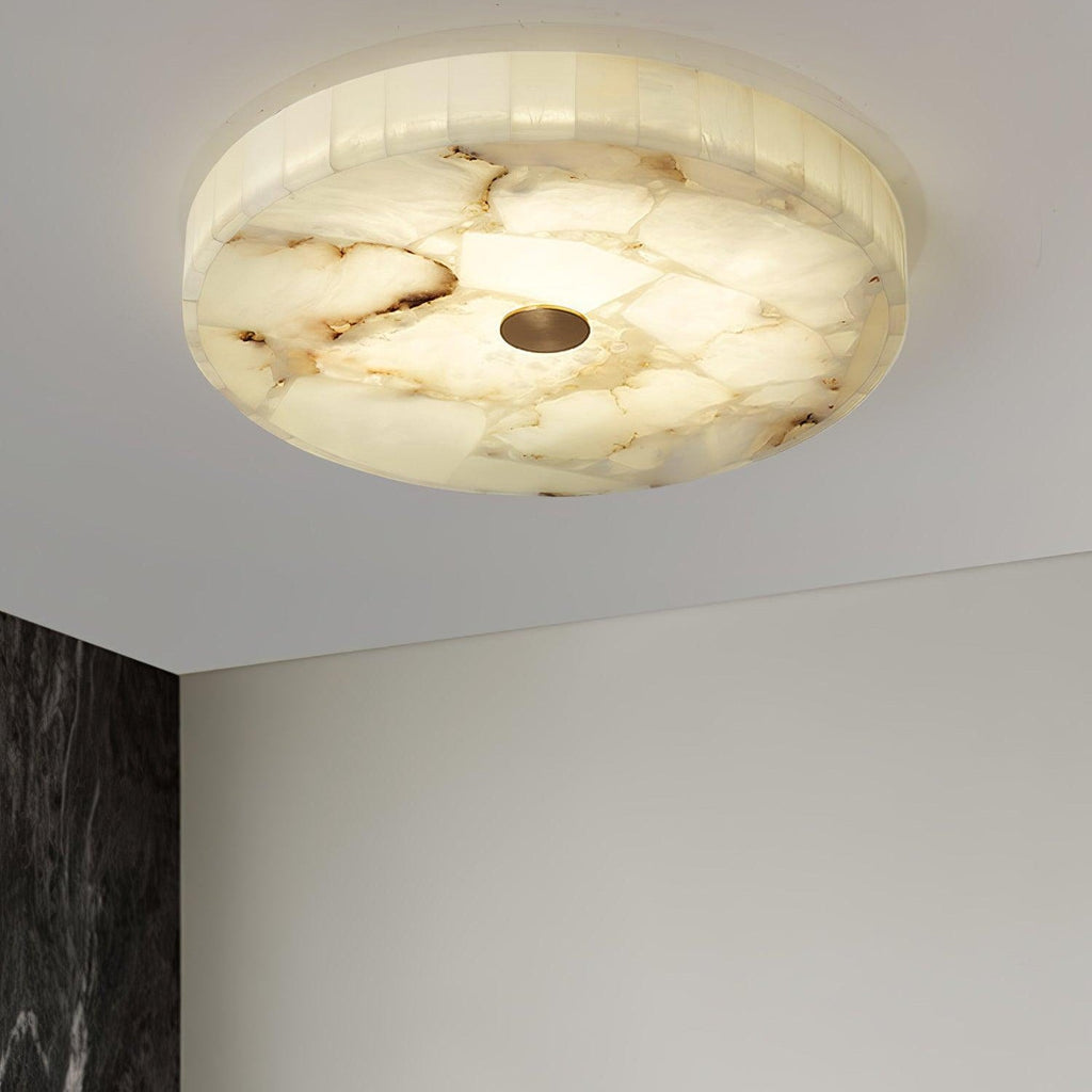 Distant view of the lit flushmount, the room below showing a white wall and dark marble edge