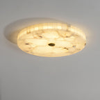 Kristy ceiling lamp lit at an angle, showing the ring of alabaster tiles that forms its side band