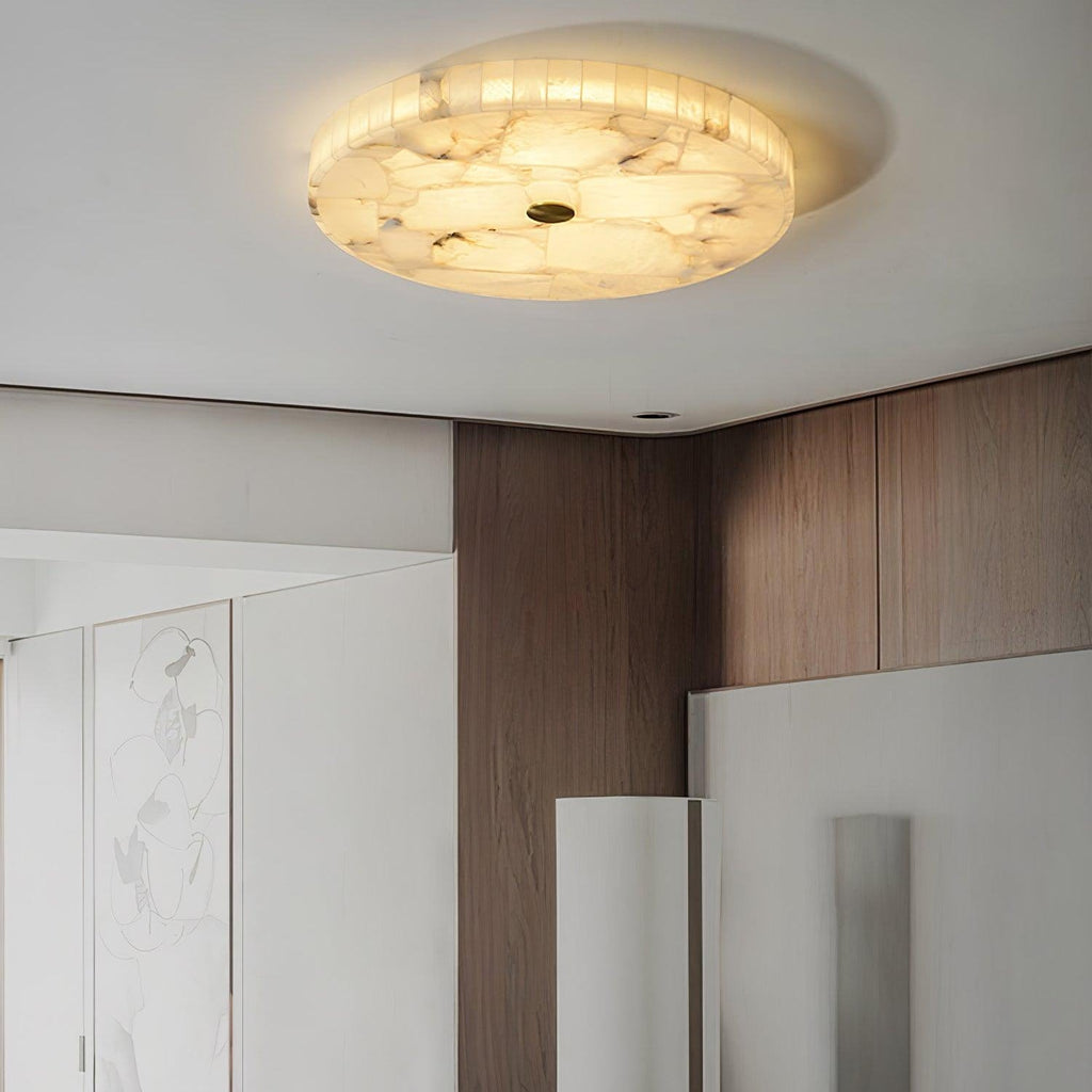 Closer view of the flushmount above walnut cabinetry and a white sculptural floor screen