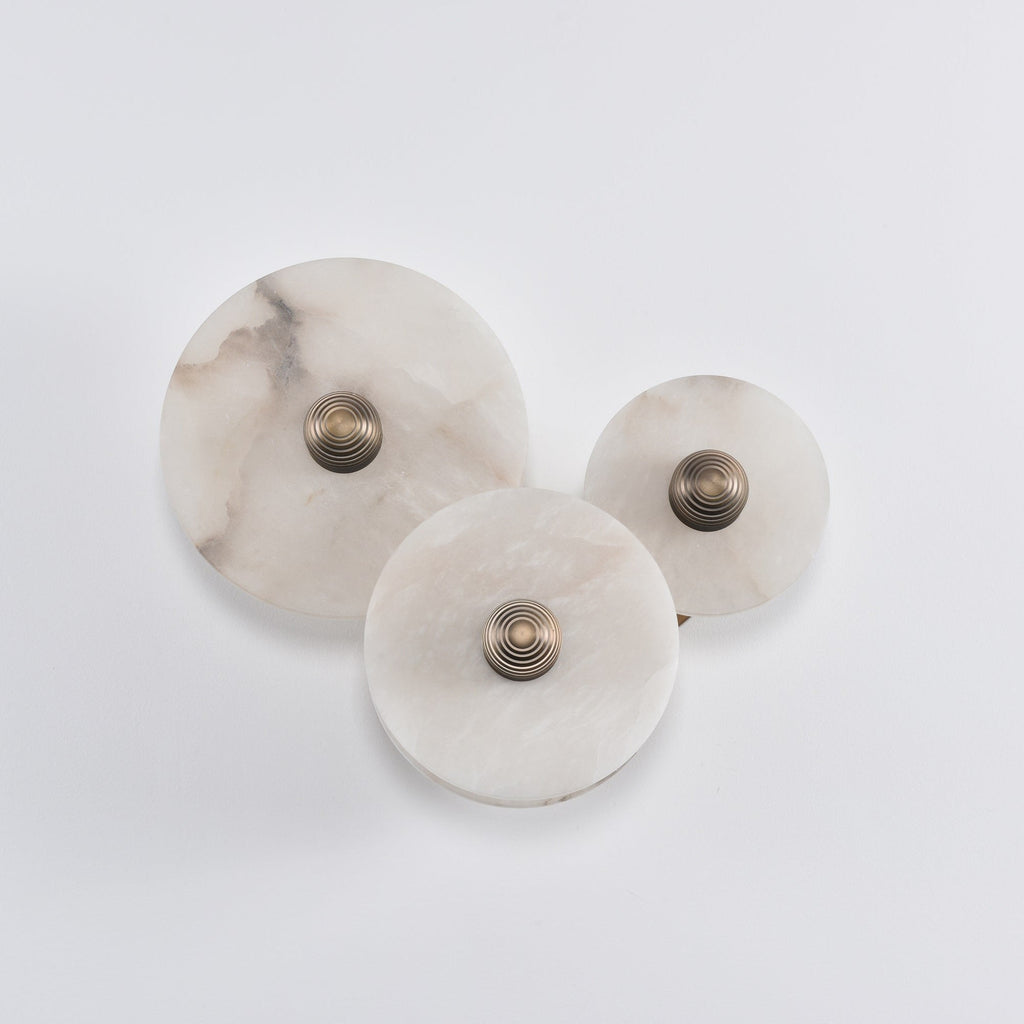 Three-disc alabaster cluster switched off, showing the natural grey and cream veining in daylight.