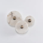 Three-disc alabaster cluster switched off, showing the natural grey and cream veining in daylight.