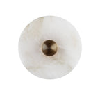 Clérachic close crop of the alabaster disc and its concentric gold boss, with caramel veining running through the stone.