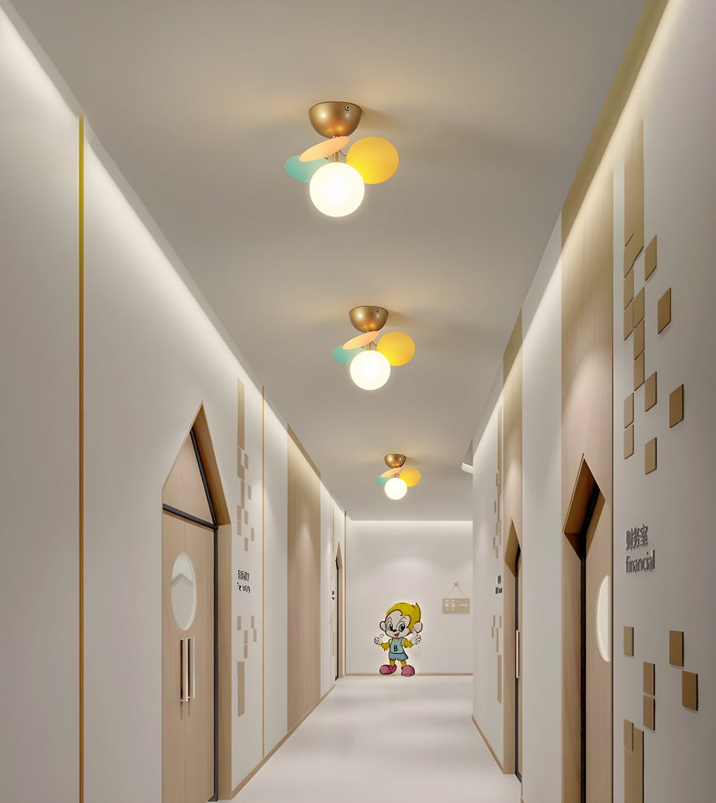 Pastel macaron ceiling lamp styled above a seating area