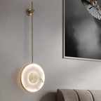 Lit on a pale wall next to a framed photograph of a bird in flight.