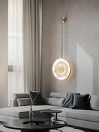 Lit in a living room beside sheer curtains, a grey sectional and black coffee table below.