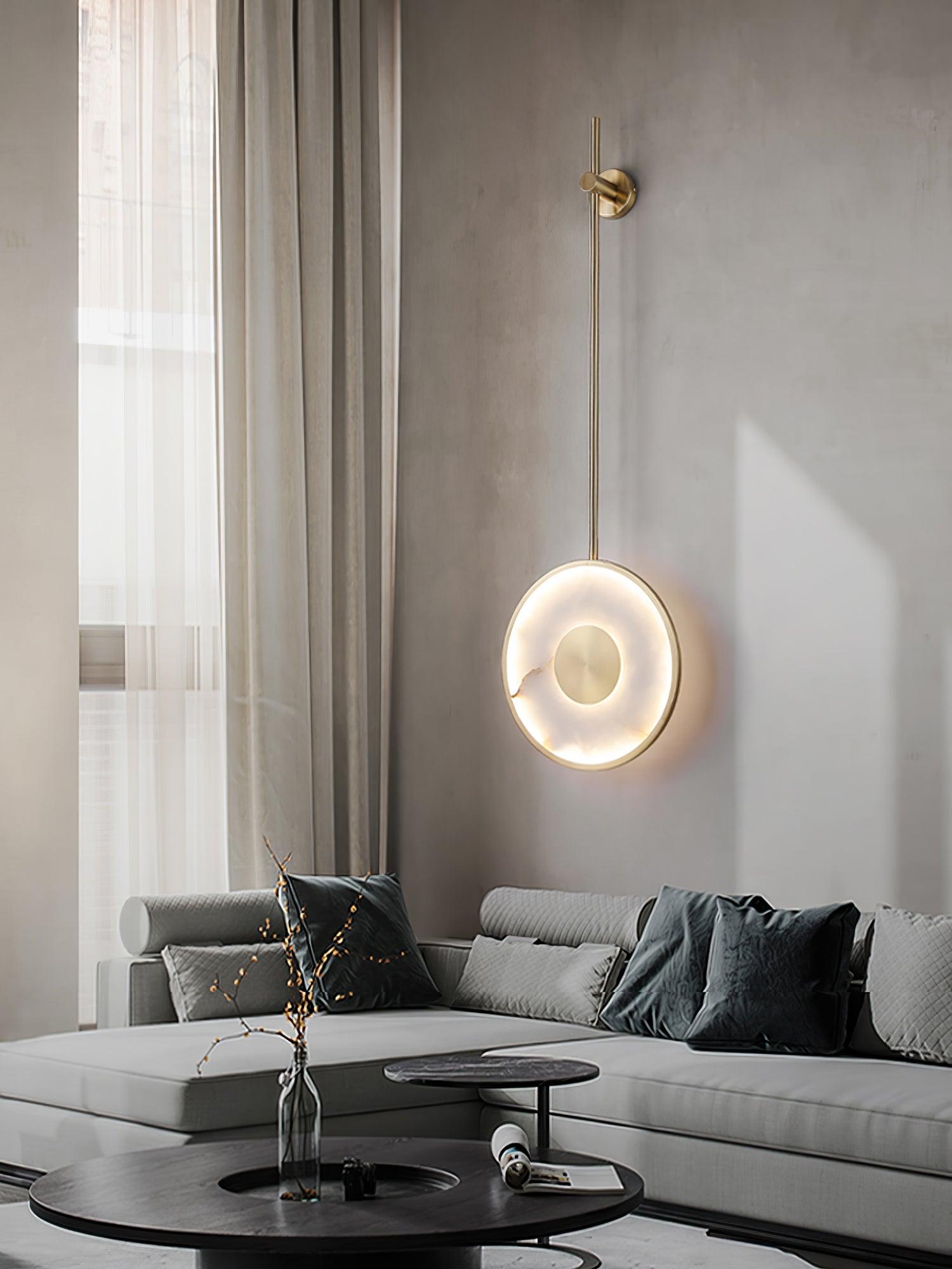 Lit in a living room beside sheer curtains, a grey sectional and black coffee table below.
