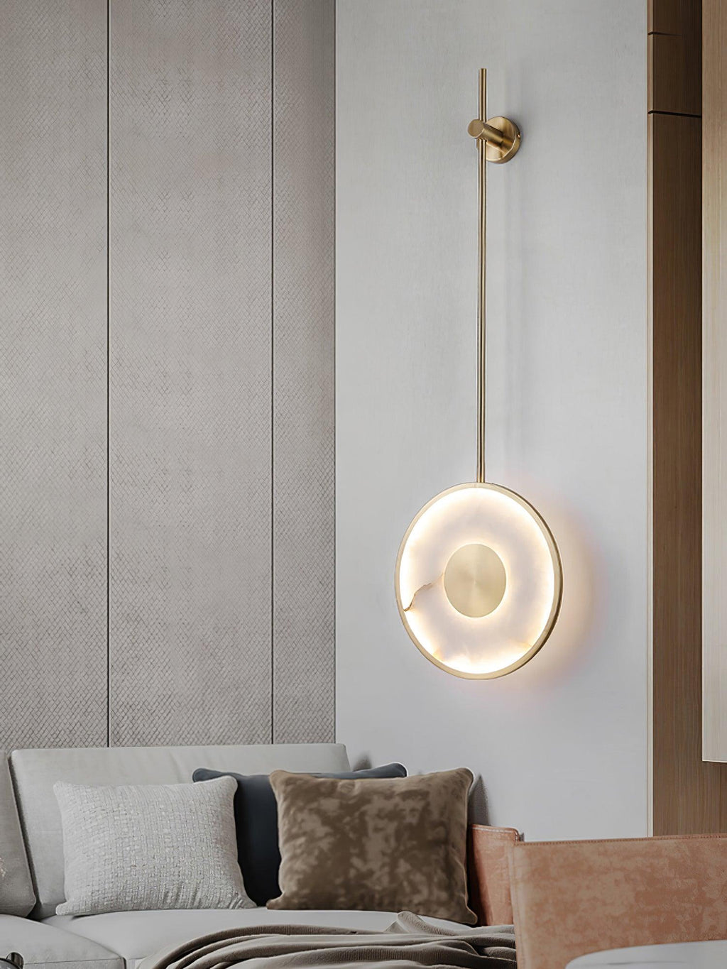 Lit against a textured wall panel above a pale sofa with a brown cushion.