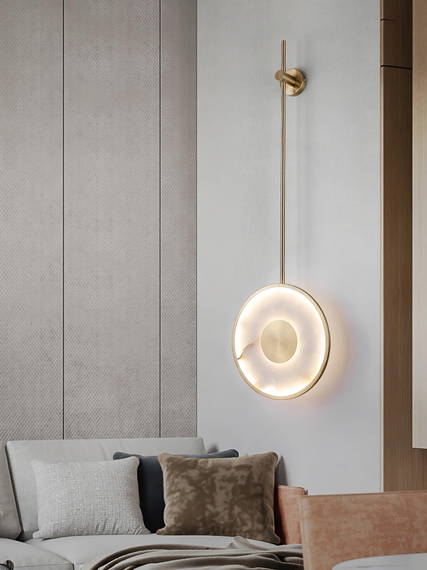 Lit against a textured wall panel above a pale sofa with a brown cushion.