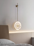 Lit above an upholstered headboard, cove lighting running along the timber wall behind.