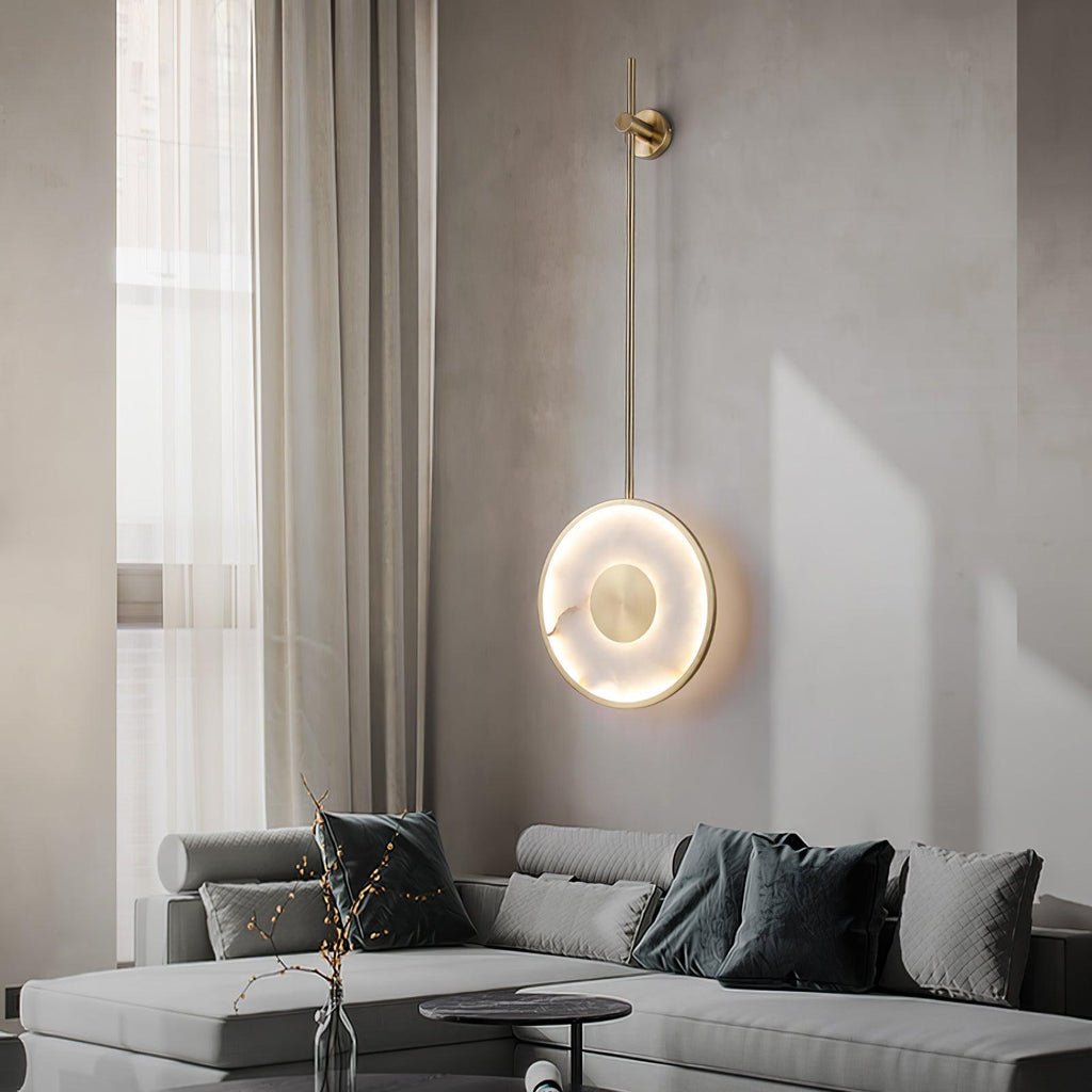 Lit in a grey living room above a sectional sofa, a round black side table below.