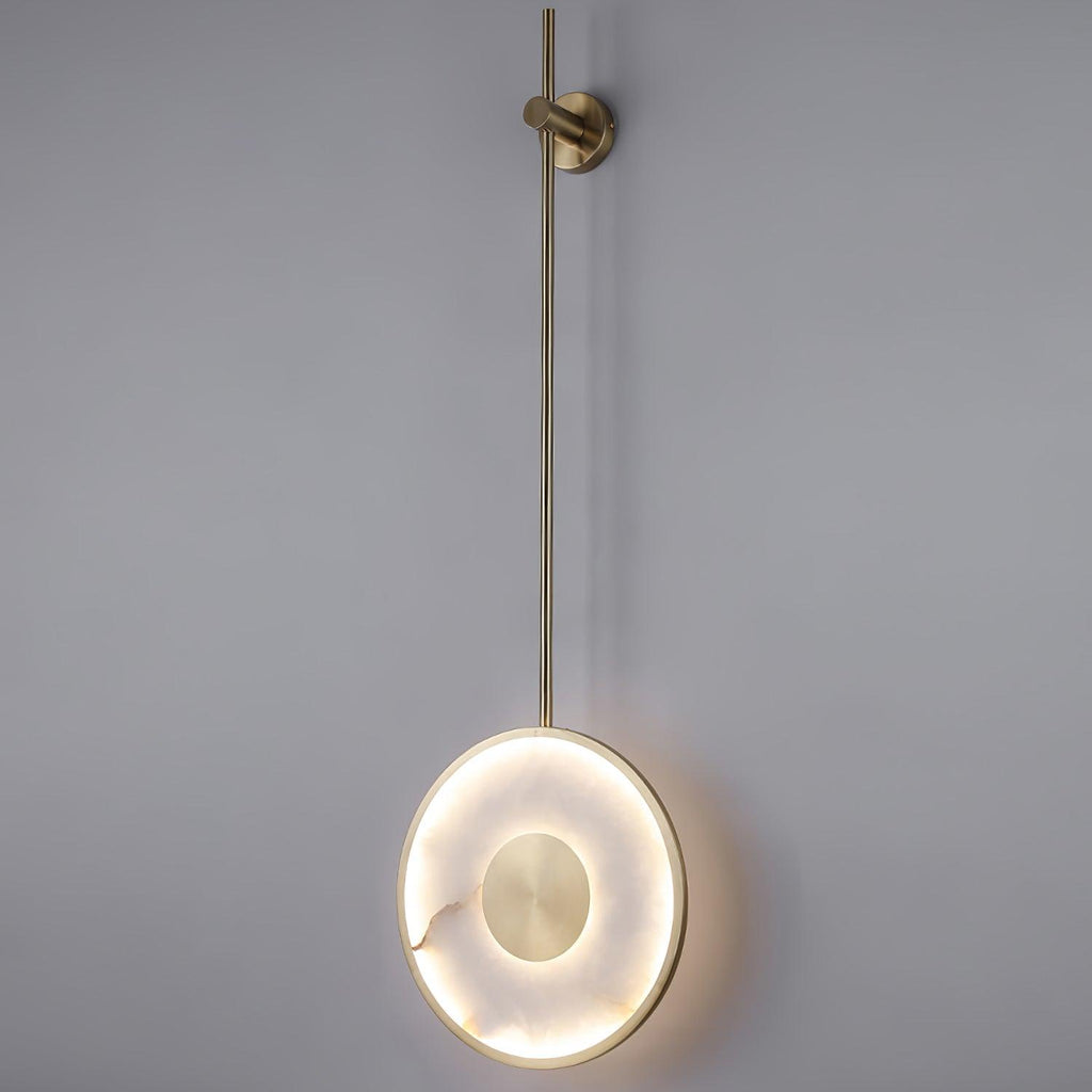 The fixture lit on grey, showing the full rod drop and the halo around the disc.