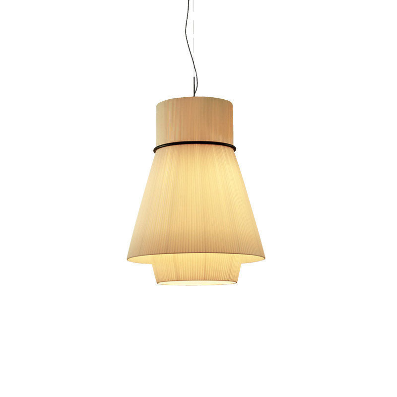 This Clérachic pendant's pleated beige shade glows warm on a wide flared rim, hanging alone against a plain backdrop.