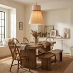 Dried flowers and a window seat sit near a farmhouse table with a bench, lit by this pleated Clérachic pendant.