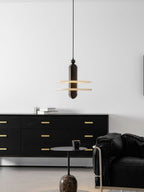 Room view of the dark bronze Saturn pendant hung over a sideboard and a leather armchair