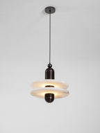 Full length of the lit Saturn pendant, both alabaster discs glowing beneath the ceiling canopy