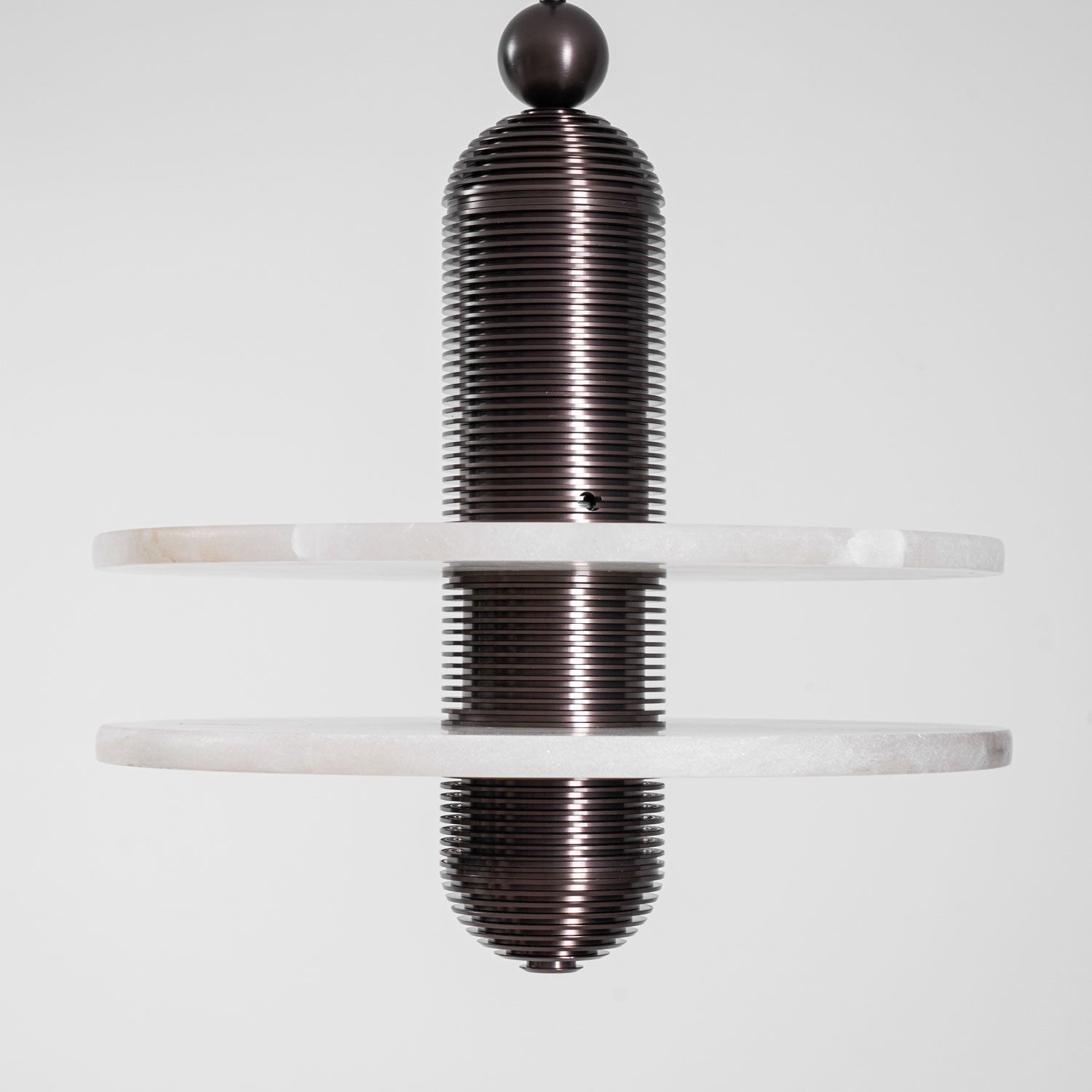 Straight-on studio crop of the dark bronze Saturn pendant with both alabaster discs, unlit