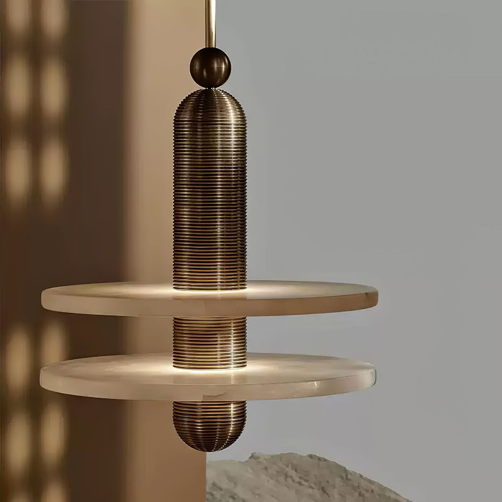 Close view of the gold Saturn pendant, ribbed column passing through two alabaster discs